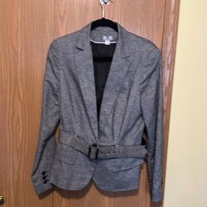A polish black and white blazer with matching belt and pockets